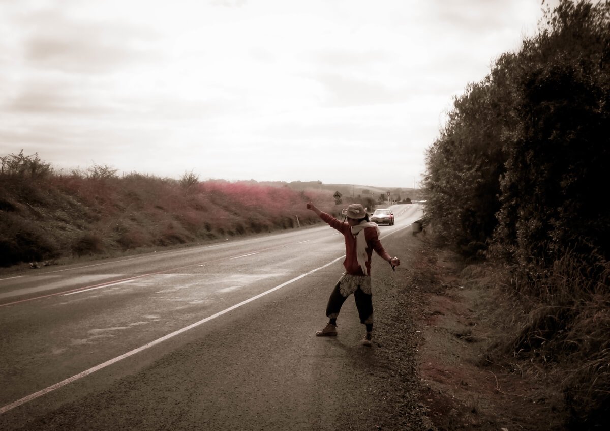 A man hitchhiking on the South Island of New Zealand