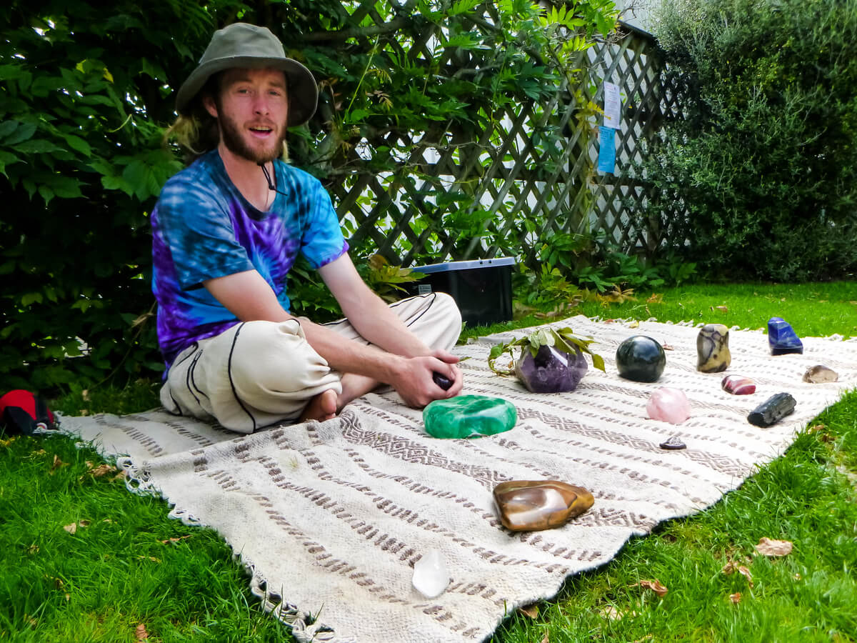 Man in the markets in Motueka showing off his crystals to travellers