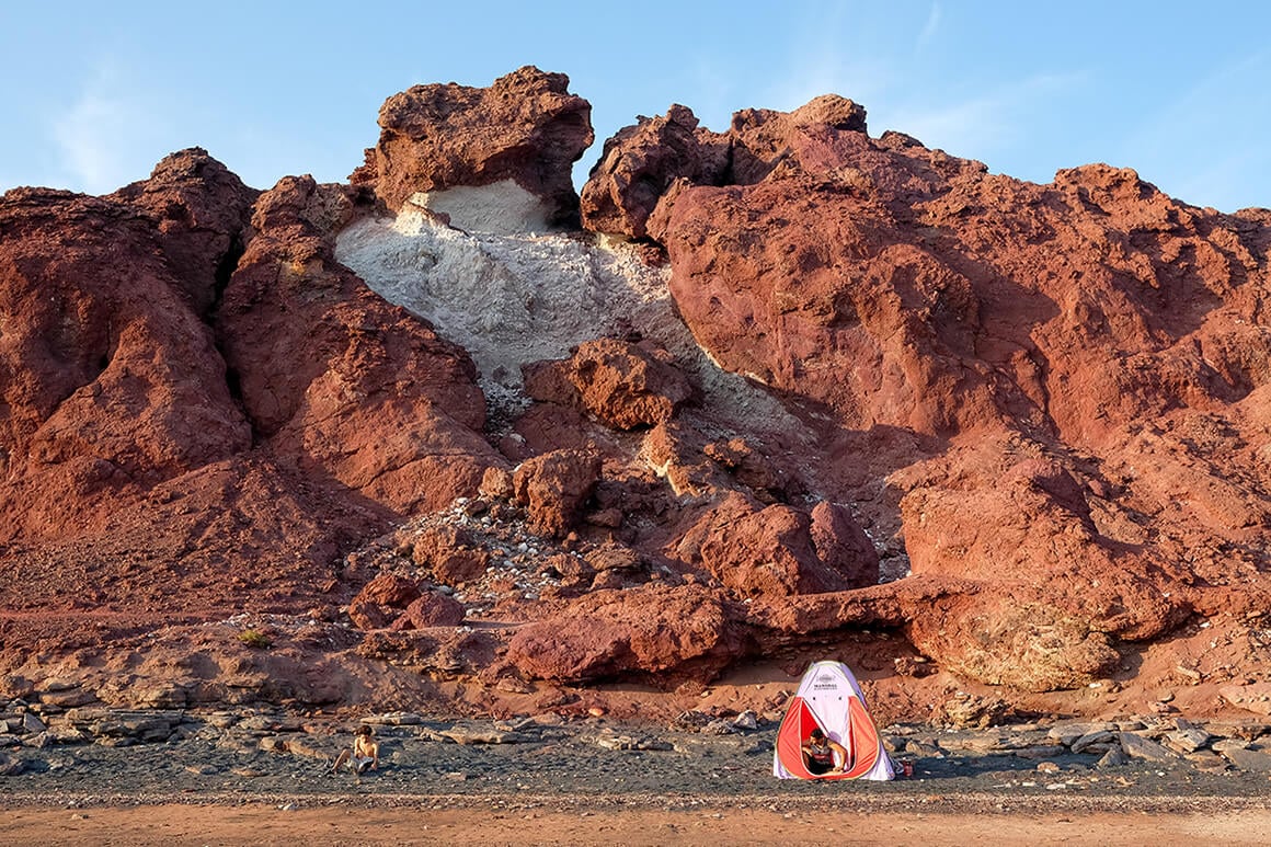 hippy campers at the red beach in hormuz island, iran