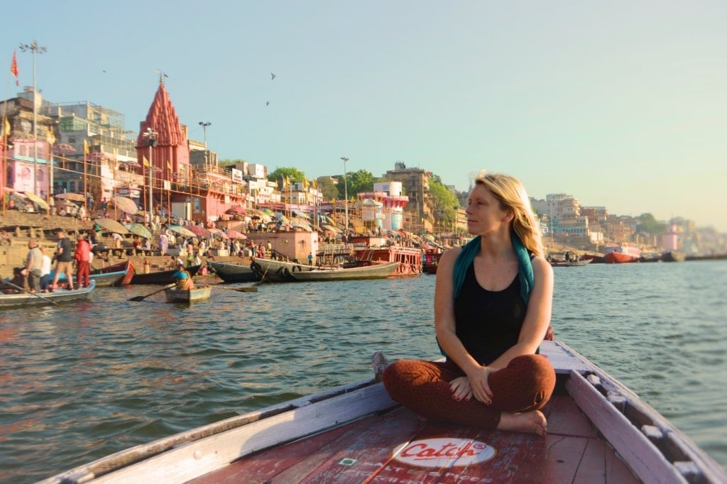 Solo female traveller backpacking in Varanasi at the Ganges River