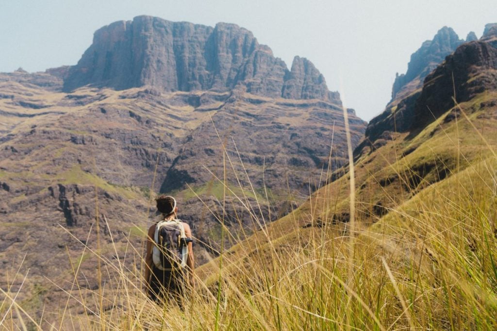 A person in a valley looking out over the mountain in South Africa