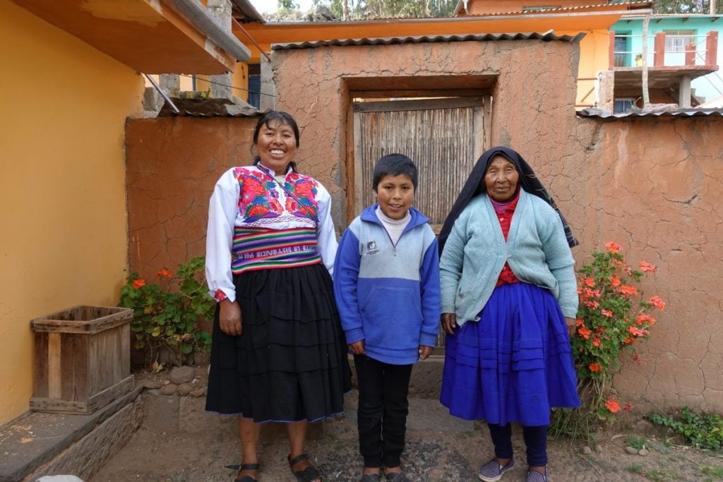 Local family dressing traditional clothes from Peru in front of their house. 