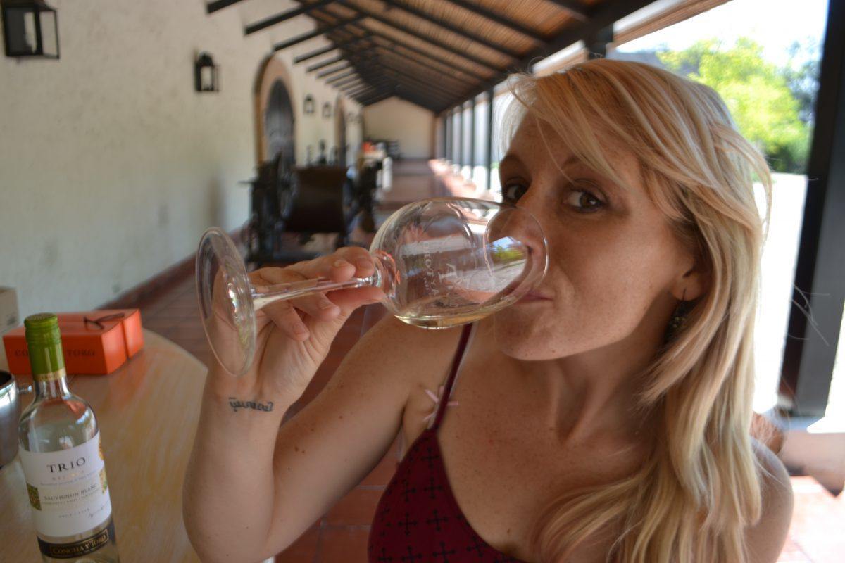 girl sipping on wine at a winery