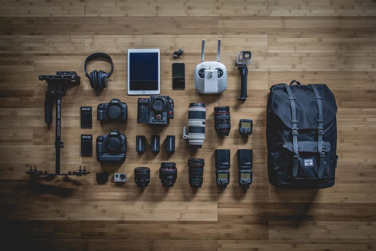 camera bapackpack overview. An overhead photo of a collection of cameras and photography gear.