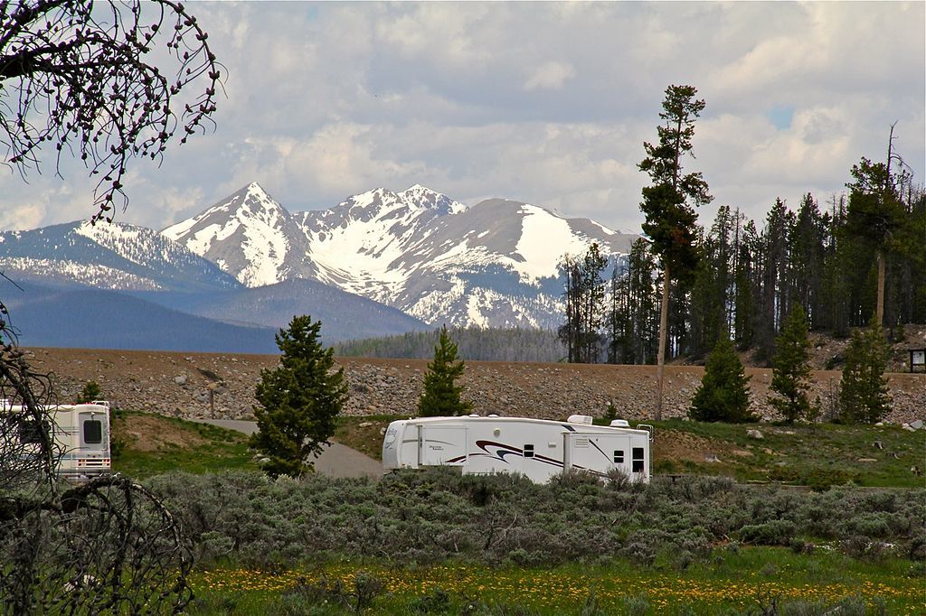 rv trailer in colorado woods with mountains
