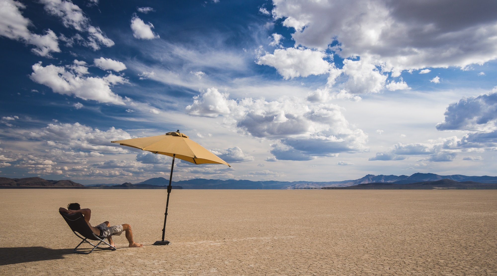 lounging in the alvord desert with an umbrella eastern oregon road trip