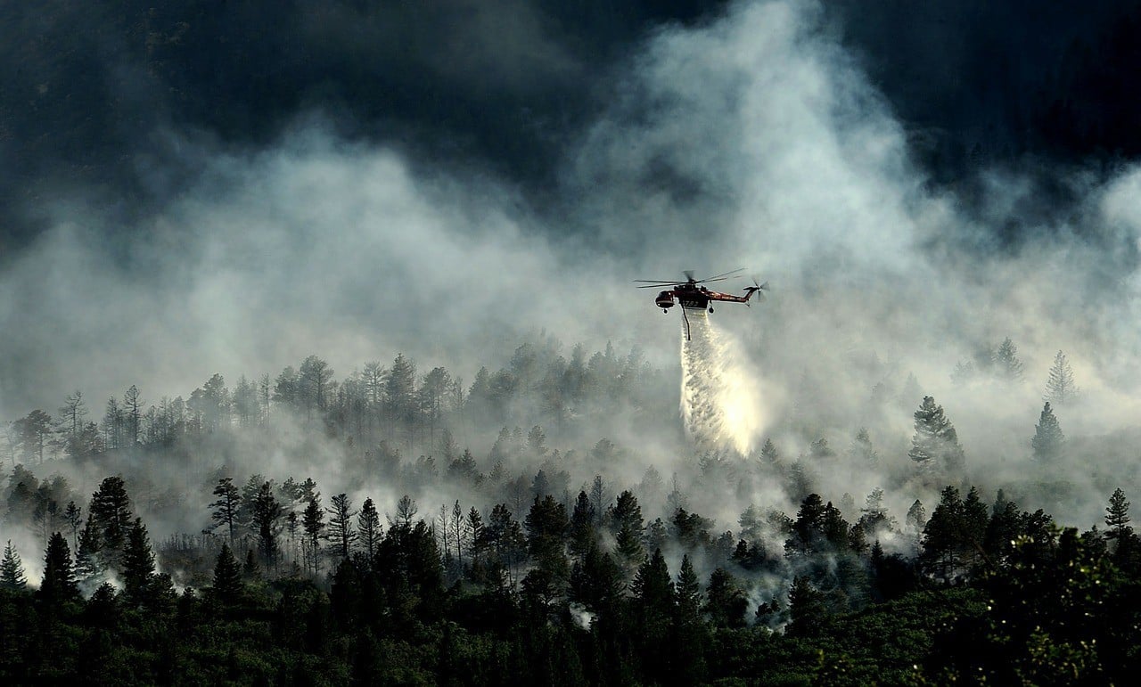 HELICOPTER fighting forest fire in colorado