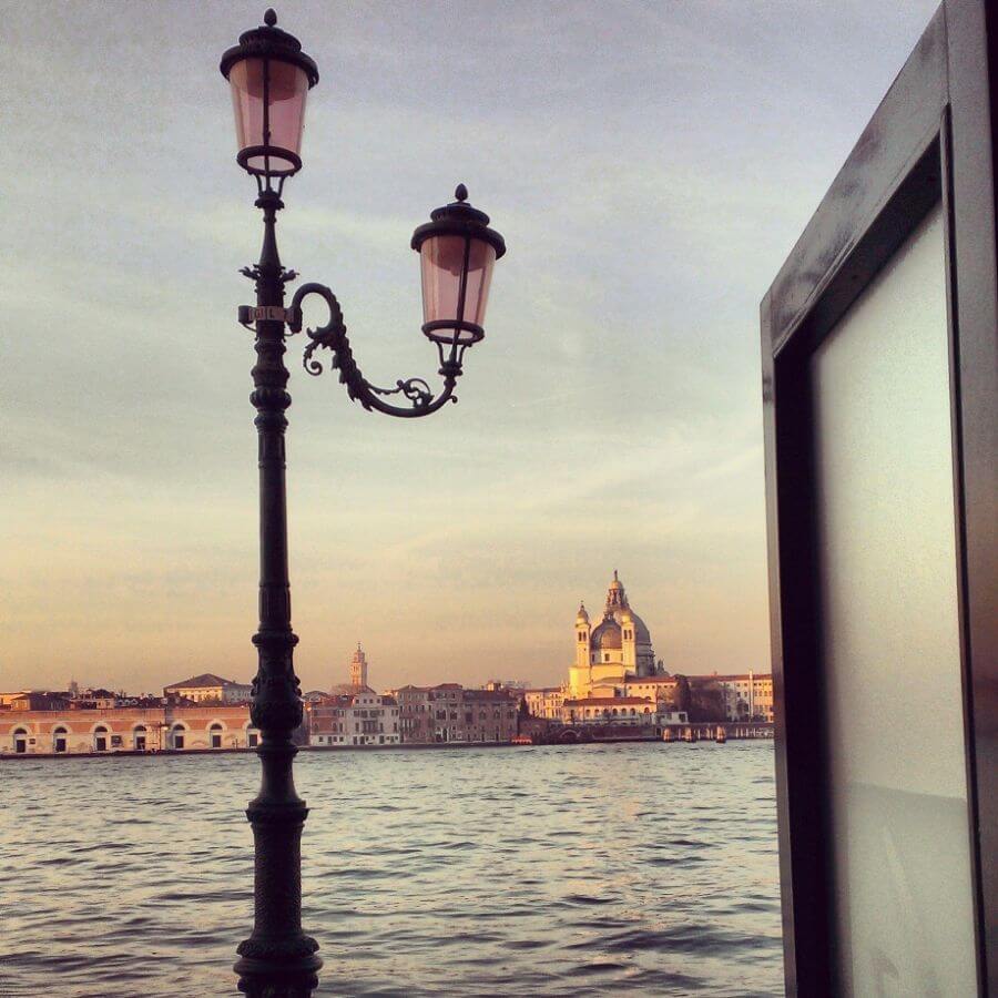 Water and old buildings of Venice Italy around sunset