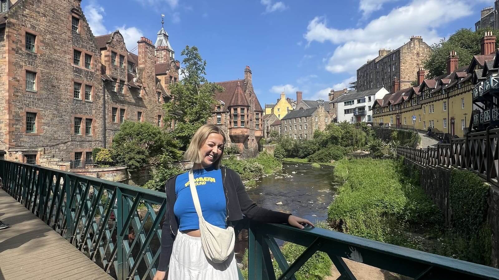 girl posing in front of bridge in dean village, edinburgh