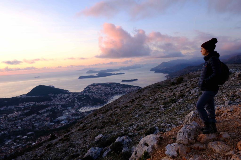 woman looking out to the ocean at sunset, backpacking croatia