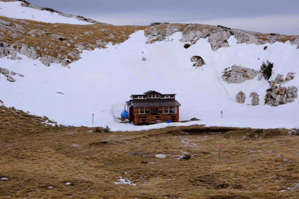 A hut surrounded by snow in the mountains in Croatia