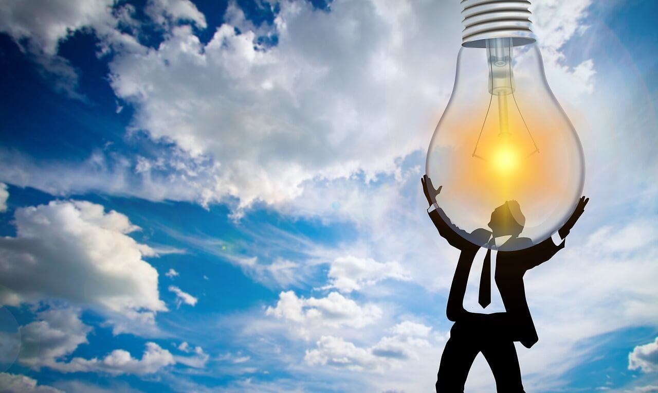Man holding a lightbulb because his brain is overflowing with new vocabulary