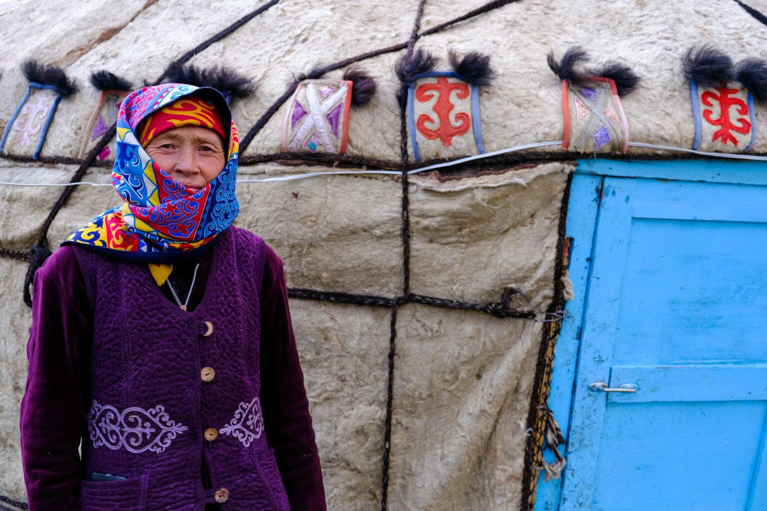 local woman outside yurt in kyrgyzstan
