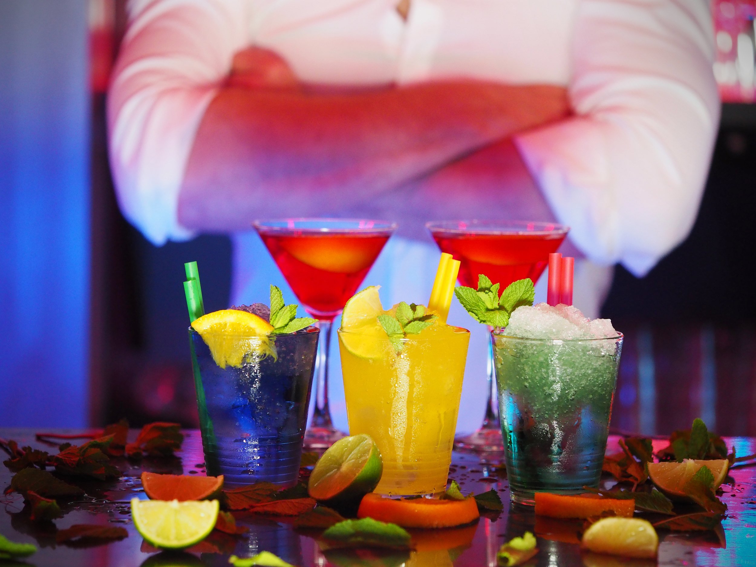 a bar tender standing behind his cocktail creations on Upper Penang Road