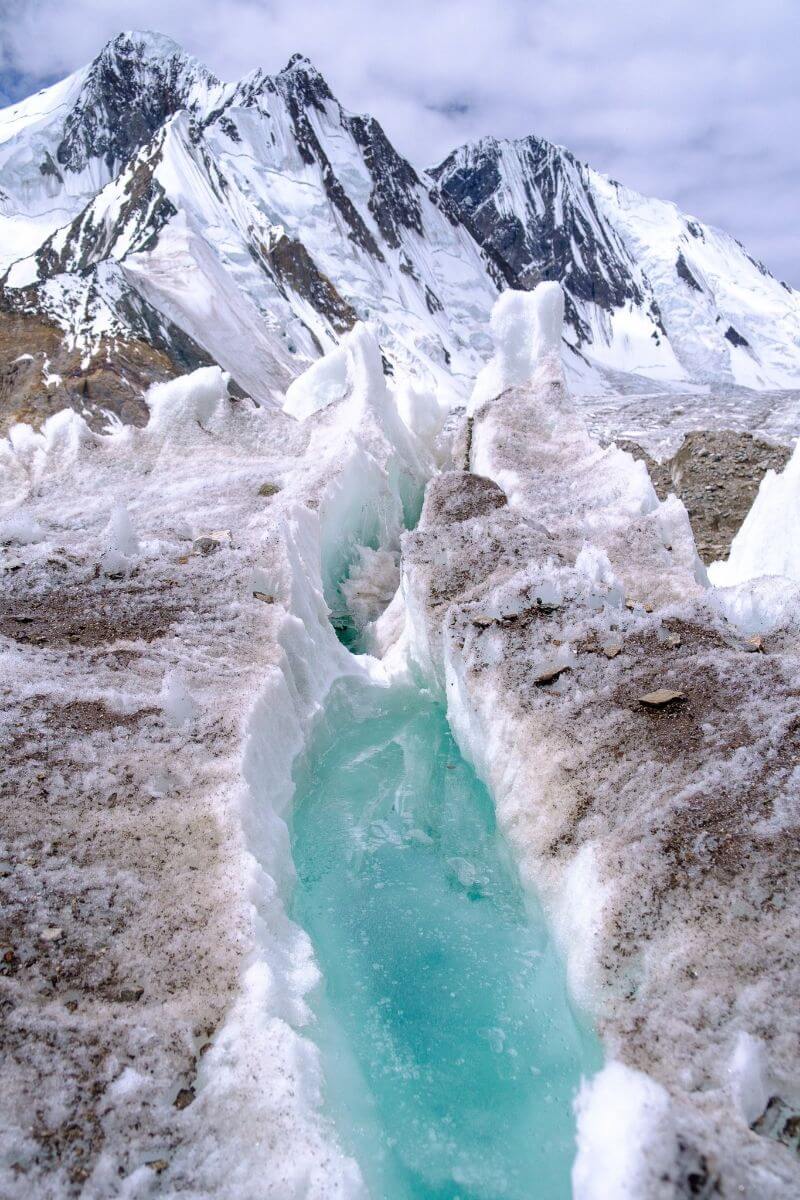 Aqua coloured ice in a glacier in a valley in pakistan on the K2 base camp hike