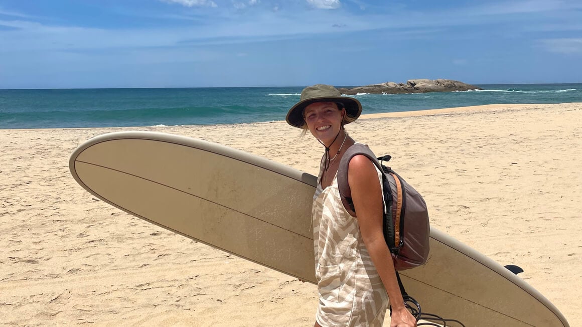 danielle with a surfboard at the beach in Sri Lanka