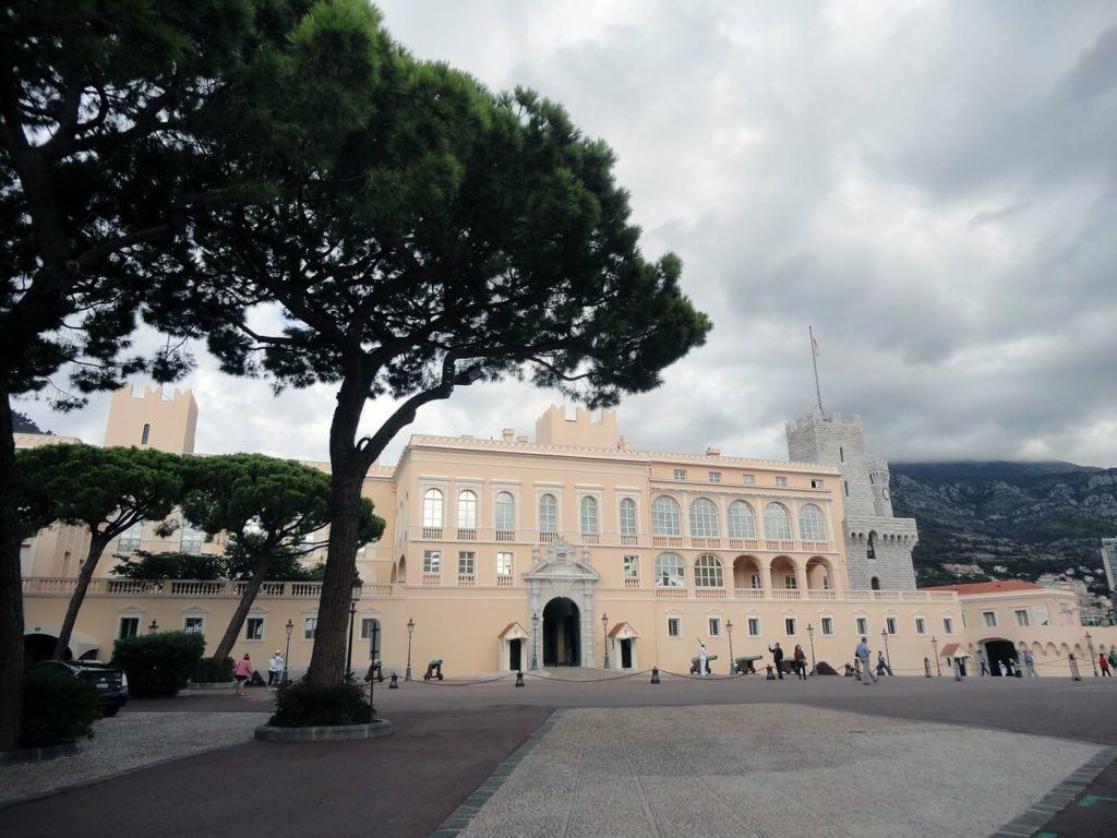 the tan prince's palace of monaco as seen on a cloudy day