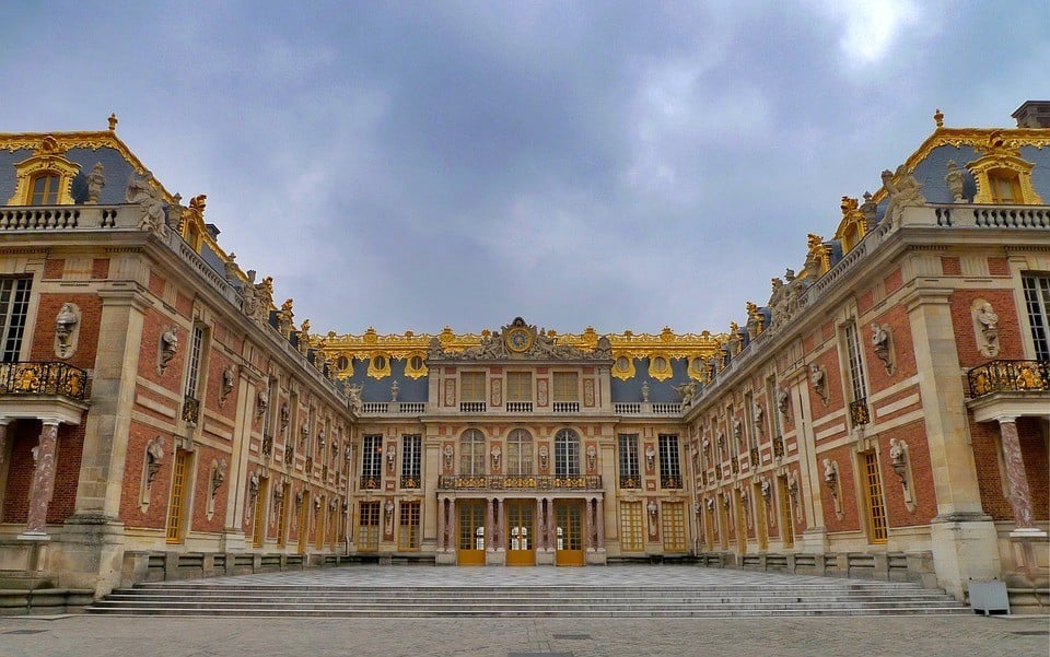 The prestigious, ornate Palace of Versailles, with its marble courtyard, in Paris