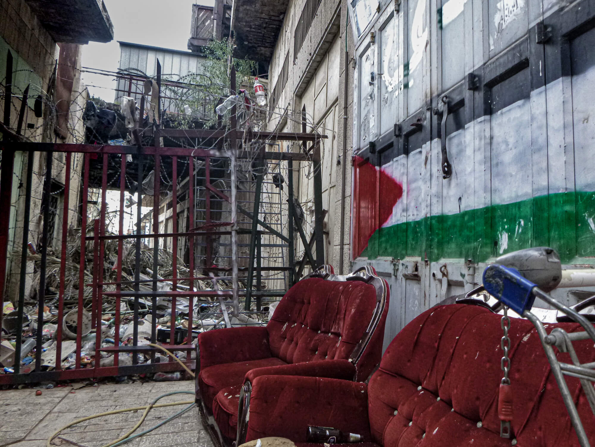 Street art and in a rundown alleyway in Hebron - a challenging place tot ravel to in Palestine