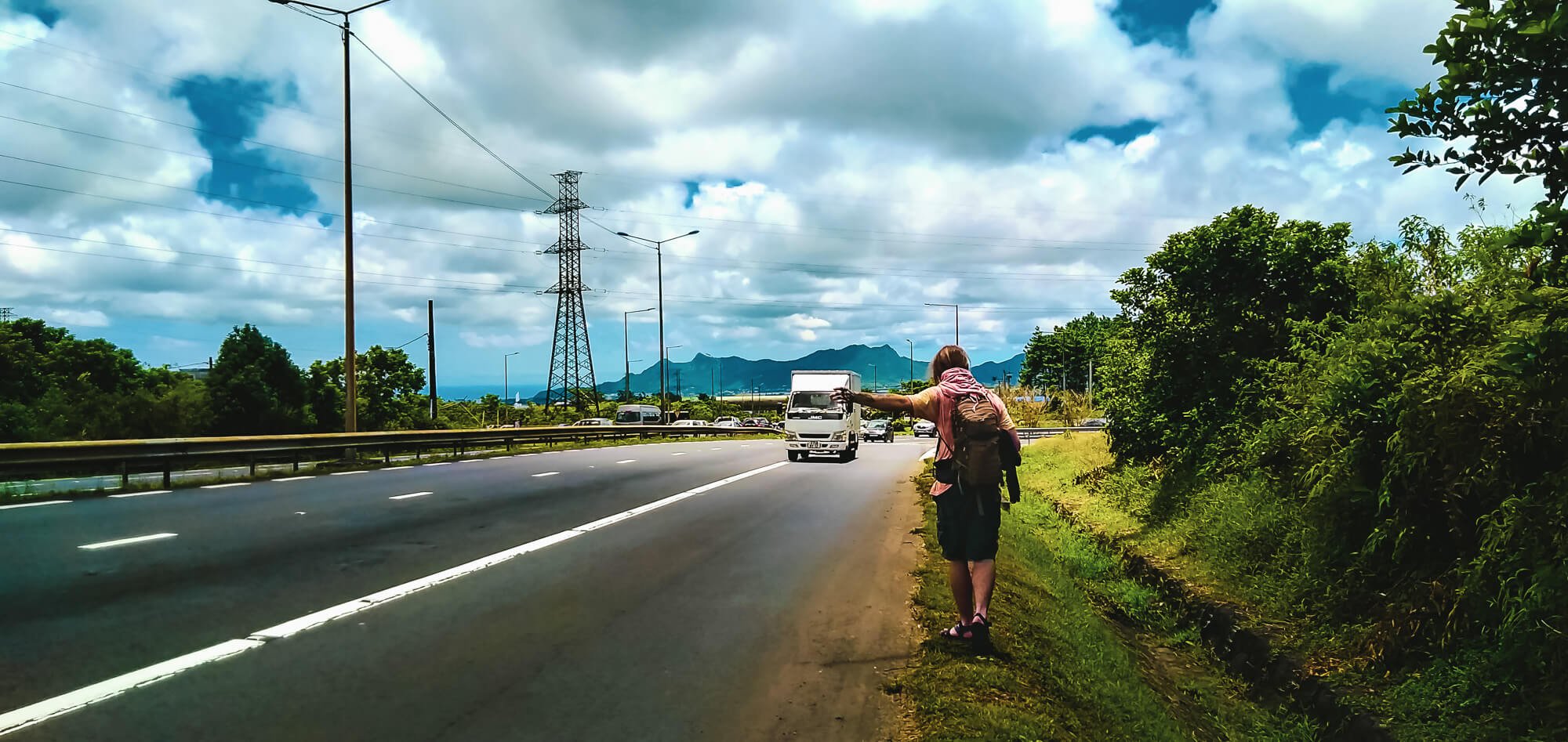 Man hitchhiking in Mauritius with a long-term travelling friend
