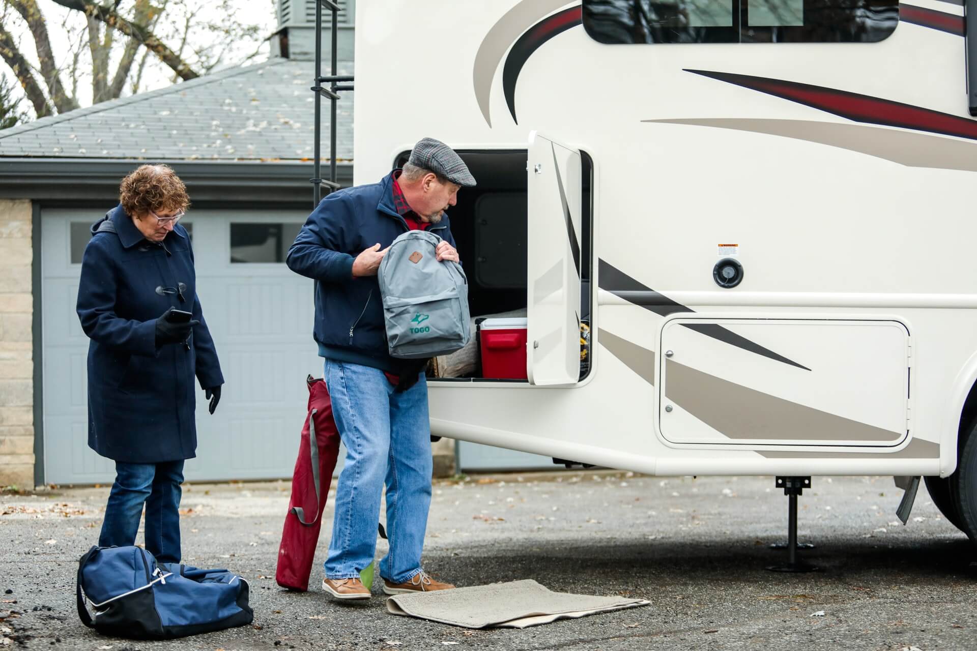 An old couple packing the RV for a road trip