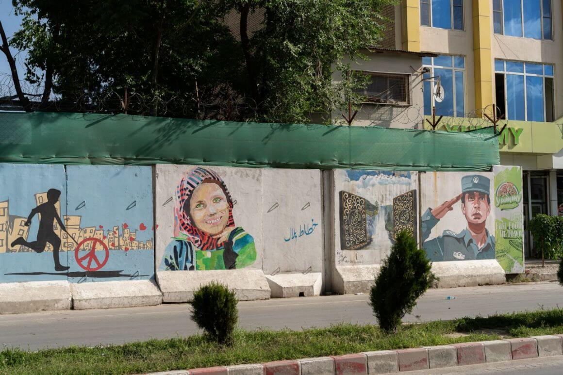 A blast wall in Kabul that has been painted with graffiti promoting peace.