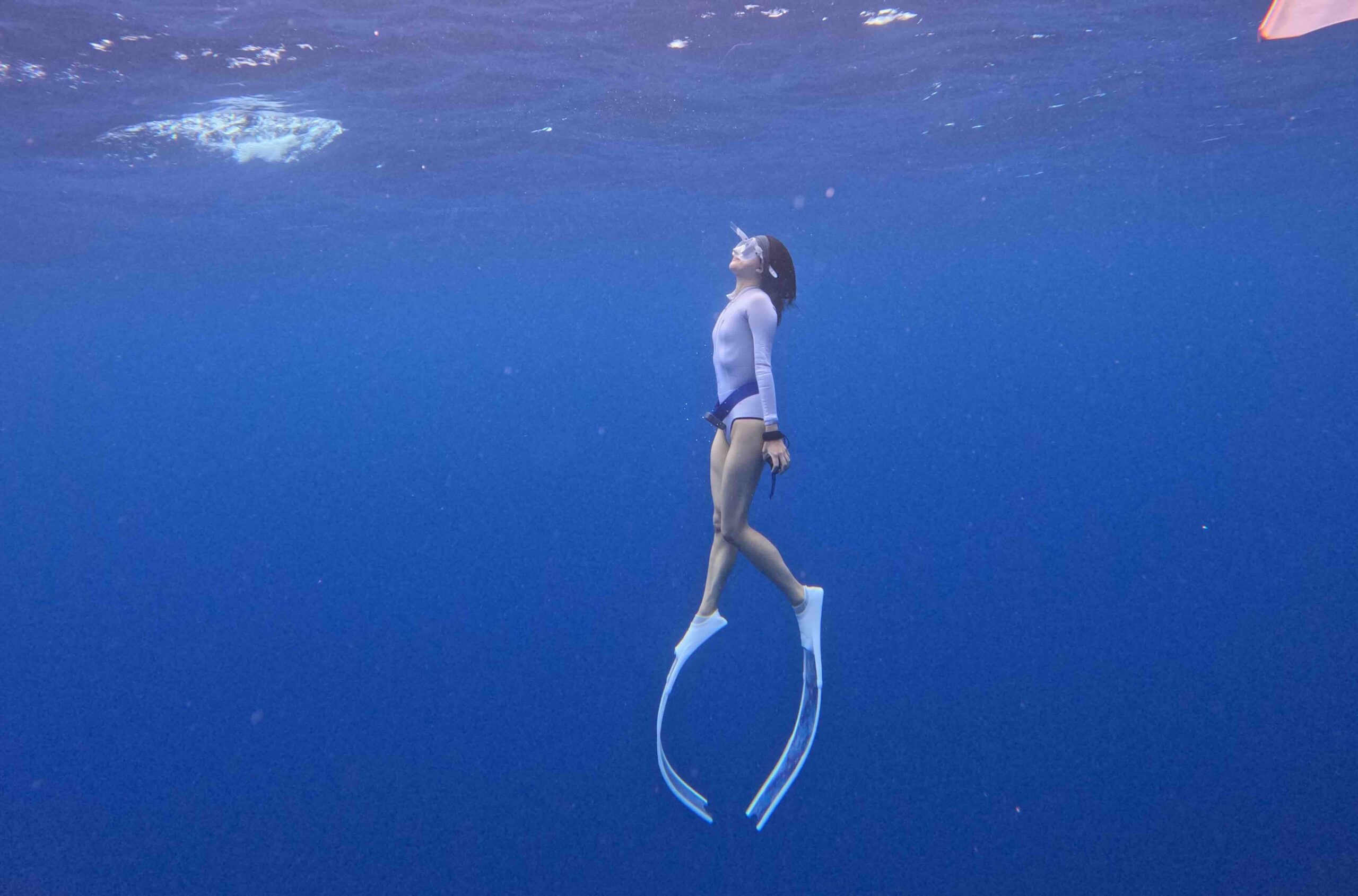 A photo of a girl freediving in Moorea, French Polynesia.