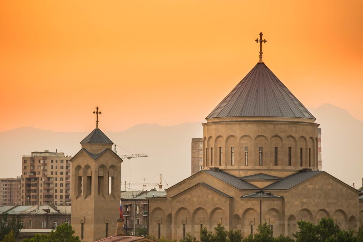 church towers against orange sky