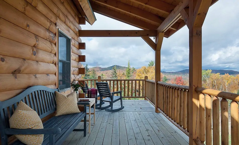 raised wooden porch with couch and rocking chairs overlooking mountains on the east coast