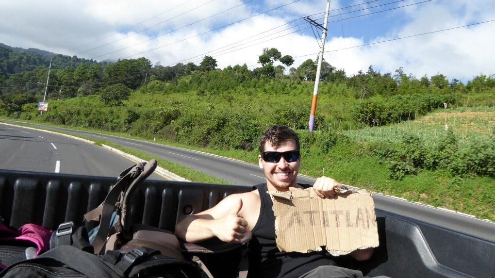 will hatton standing on the back of a pickup truck whilst hitchhiking through guatemala