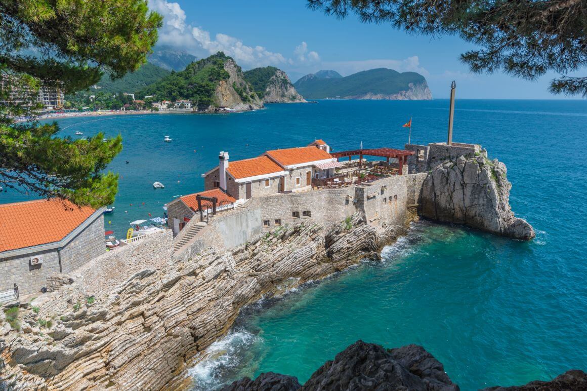 An aerial view of Petrovac Fortress, Budva on a rocky outcrop overlooking the Adriatic Sea. 