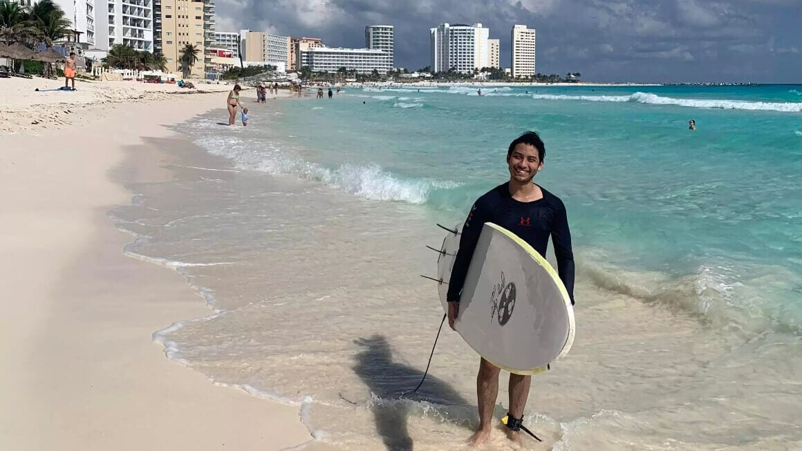 Friendly surfer local on cancun beach in Cancun mexico.