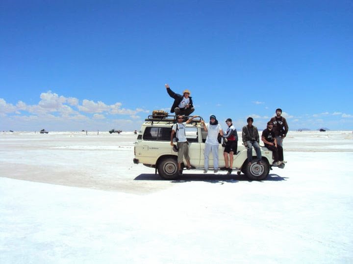 Group of travelers in Uyuni flat salt tour on top of the truck.