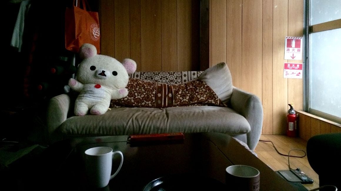 couchsurfing living room couch in kyoto, japan, with teddy bear