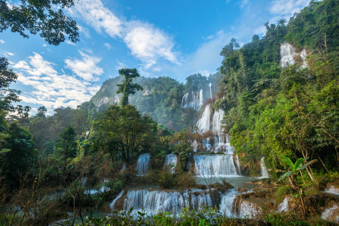 Thi Lo Su Waterfalls surrounded by lush forest in Thailand