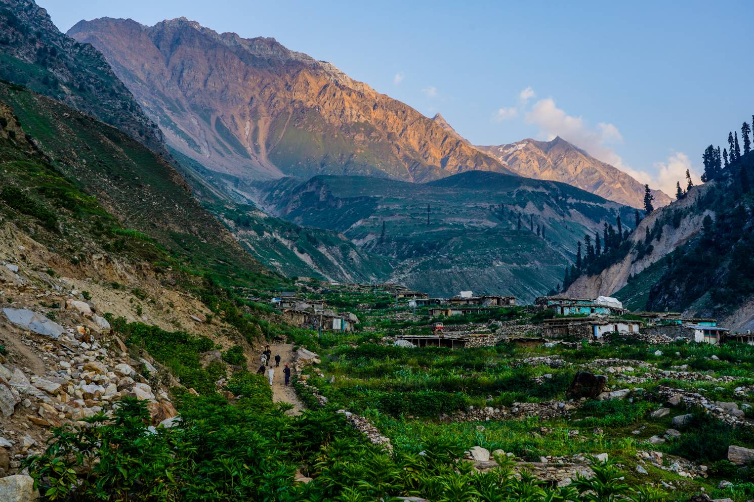 sunset over a lush green village in the naran region of pakistan