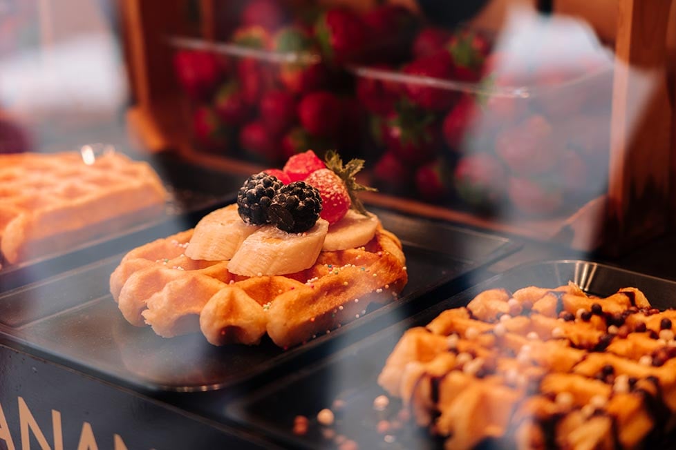 A tasty Belgian waffle with fruit on top