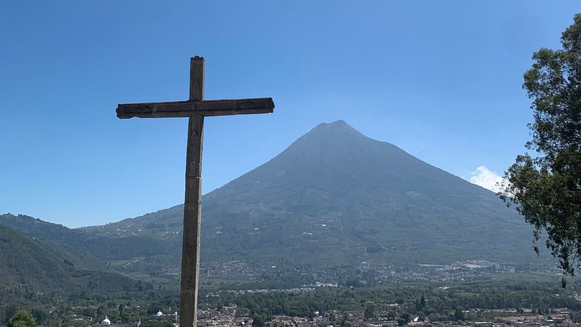 Volcano in Antigua Guatemala with cross in the foreground