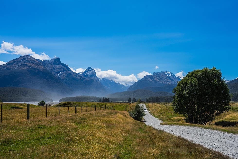 A gravel road leads to the mountains in Wanaka, New Zealand