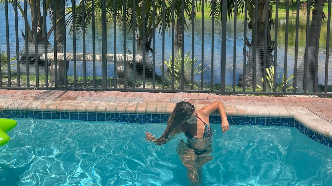 a girl standing in a pool in Florida, USA United States of America.