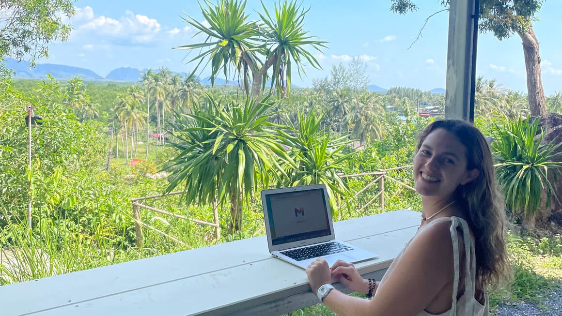 a girl working remotely from the jungle in thailand