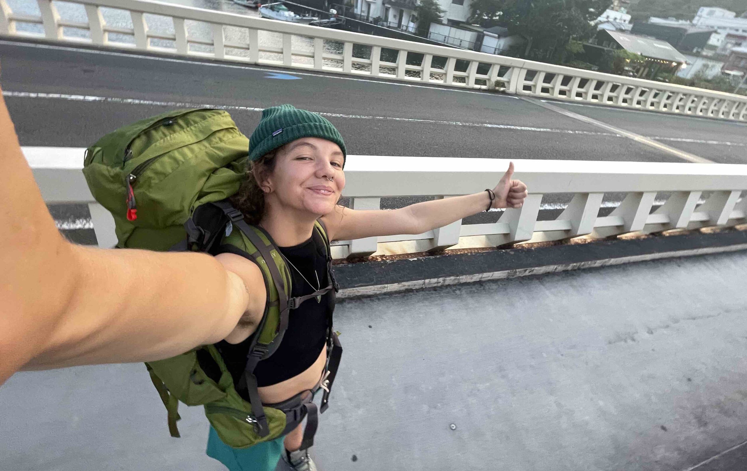 A girl takes selfie whilst hitchhiking in Japan.