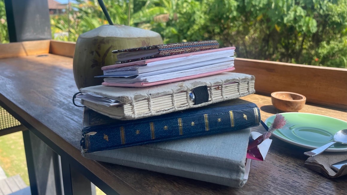 A stack of various travel journals