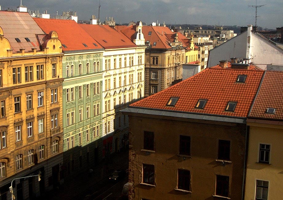 Looking down a street with pastel coloured traditional houses in Prague, Czech Republic