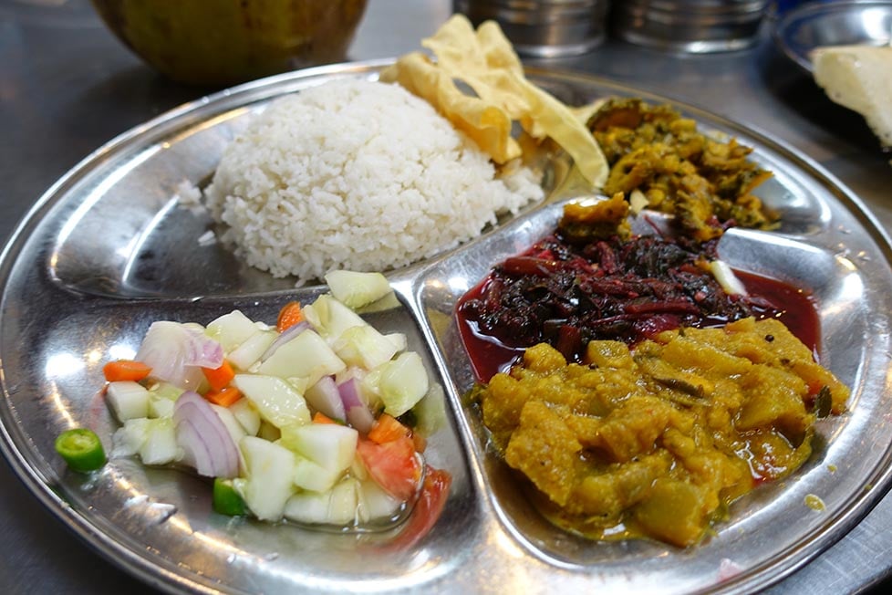 A metal tray of vegetarian food, thai, indian food.