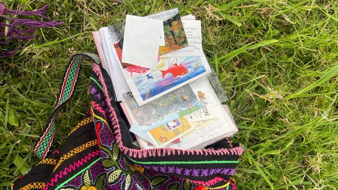 A journal spilling out with treasures collected from travels.