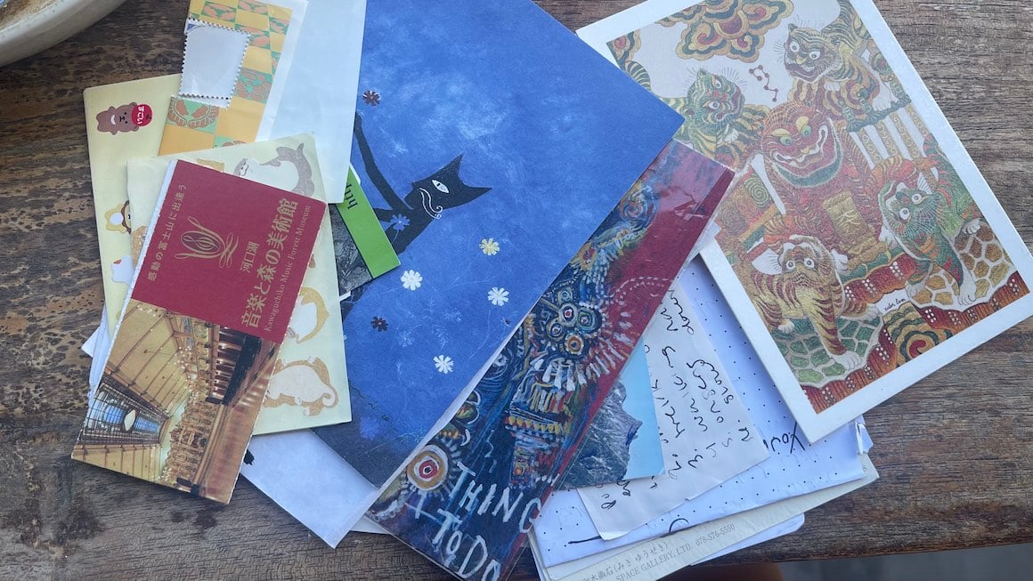 A pile of trash, scraps, post cards etc. from travels