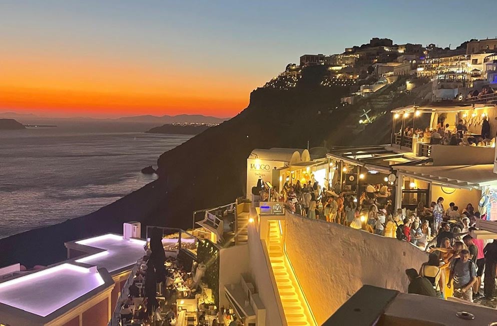 scenic sunset over the buildings and sea in Sanotrini, Greece