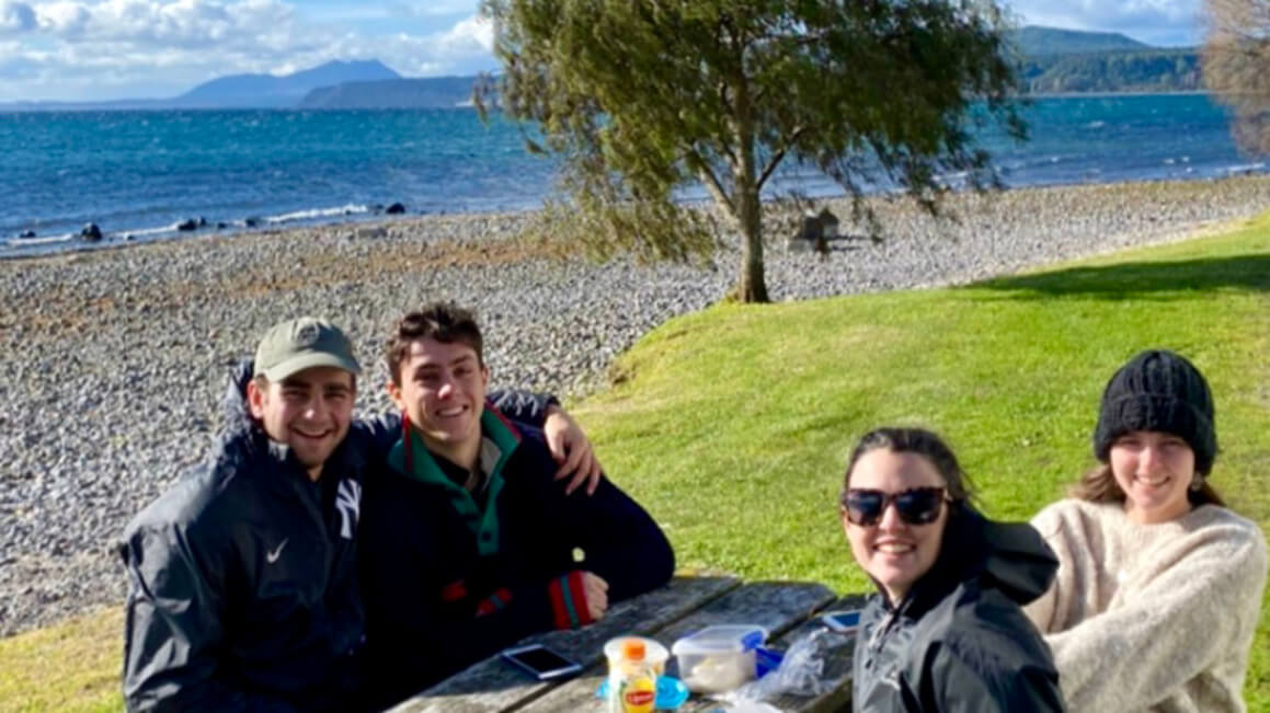 dani and friends having a picnic by lake taupo in winter, new zealand