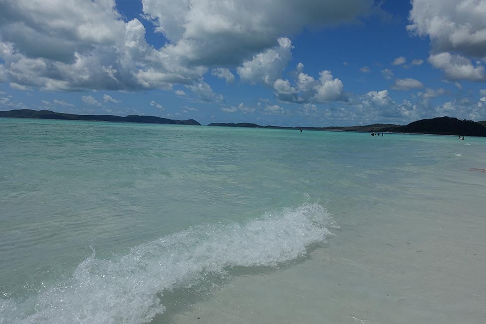 Looking out over the different shades of aqua, clear water and white sand of Whitehaven beach n Queensland, Australia.